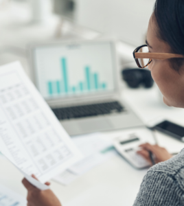 Employer reviewing a pharmacy benefits savings report showing projected and realized savings