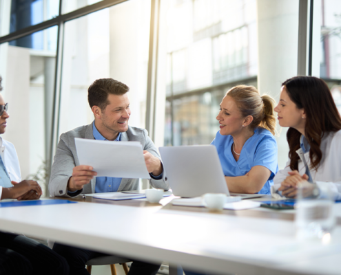 Business benefits professionals reviewing pharmacy benefit options and partnership requirements for employer health plans.