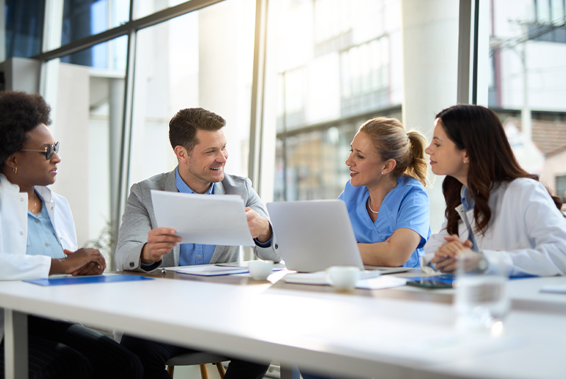 Business benefits professionals reviewing pharmacy benefit options and partnership requirements for employer health plans.