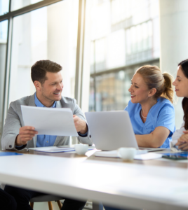 Business benefits professionals reviewing pharmacy benefit options and partnership requirements for employer health plans.